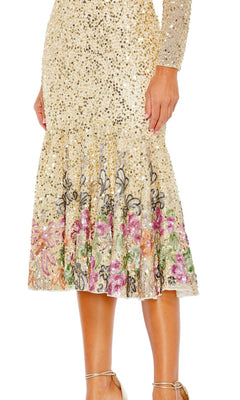 A person wearing the Beaded Midi Wedding Guest Dress: Mac Duggal 5589, a gold sequin tea-length dress with long sleeves, a flared skirt, and multicolored floral embroidery near the hem.