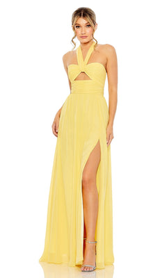 A woman wearing the Long Formal Dress 55898 by Mac Duggal, featuring a yellow ruched halter neck, front cutout, and high side slit, paired with silver high-heeled sandals.