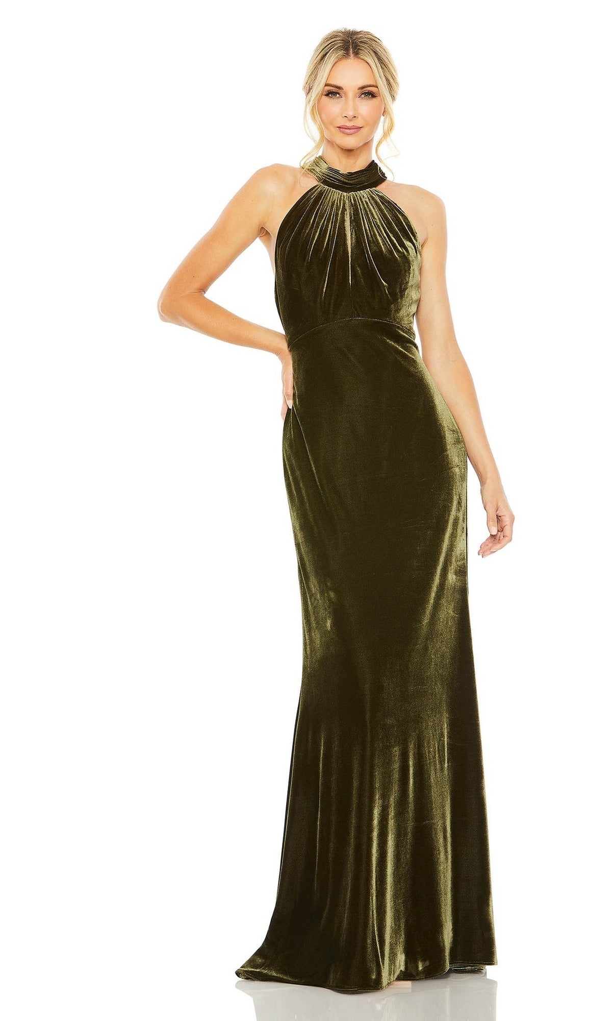 A woman stands against a white background wearing the Mac Duggal Long Formal Dress 55954, a sleeveless floor-length green velvet gown featuring a high neckline and gathered detailing.