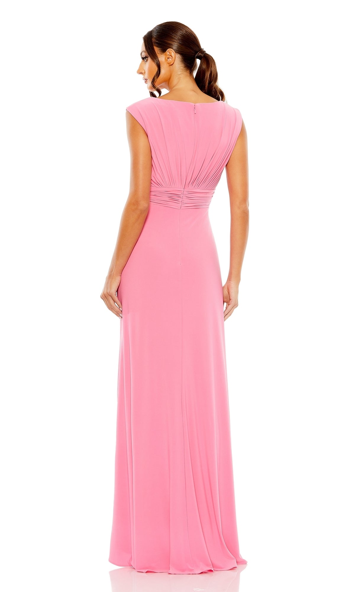A woman stands facing away from the camera in the Long Formal Dress 55974 by Mac Duggal, a candy pink, floor-length gown with ruched fabric and gathered detailing at the back.