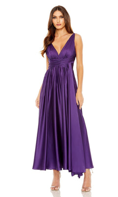 A woman wears the Mac Duggal 56035 purple midi wedding-guest dress with a sleeveless, deep V-neck and asymmetrical hem, paired with nude heels—a chic choice for any wedding guest.