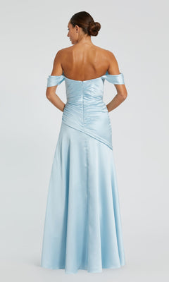 Woman standing with her back to the camera, wearing the Mac Duggal 56037 light blue off-the-shoulder prom dress, featuring a fitted bodice and flared floor-length skirt—a stunning choice for any special occasion.