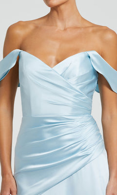 Person wearing the Mac Duggal 56037 Off-the-Shoulder Prom Dress in light blue satin, featuring a wrapped, ruched bodice and elegant draped sleeves.