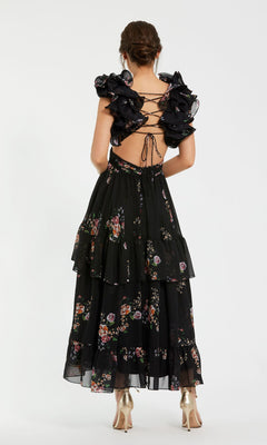 Woman wearing the Mac Duggal 56054 Cut-Out Black Print Formal Dress, featuring ruffled sleeves, a lace-up open back, and a tiered skirt—ideal for an elegant evening gown look.