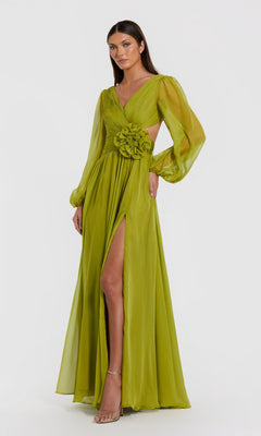 A woman wearing the Mac Duggal 56072 long formal dress in apple green—crafted in sheer chiffon with elegant bishop sleeves, a high slit, and floral detailing at the waist—stands against a plain white background.