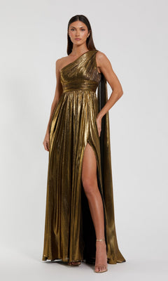 A woman wearing a gold Mac Duggal 56086 long formal dress, distinguished by its striking one-shoulder design and high slit, stands against a plain light background.