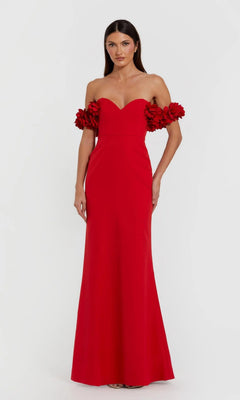 A woman wears the Mac Duggal 56131 Floral-Straps Long Formal Dress—a floor-length red gown featuring 3D floral straps—standing against a plain white background.