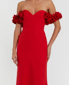 A woman wearing the Mac Duggal 56131 Floral-Straps Long Formal Dress in red, designed with off-the-shoulder 3D floral-embellished sleeves for an elegant, statement look.