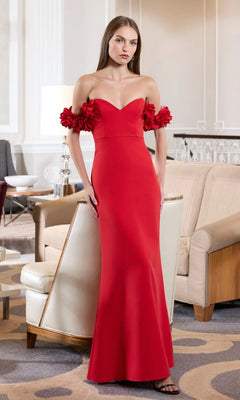 A woman stands indoors in a modern, elegant living room wearing the Mac Duggal 56131 Floral-Straps Long Formal Dress.