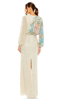 A woman in the Mac Duggal 5615 Beaded Long Sleeve Formal Dress stands facing away, showcasing floral embroidery on the back and sleeves, along with a chic back slit in the skirt.