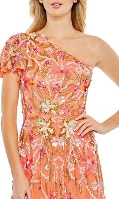 A woman wears the Long Formal Dress 5617 by Mac Duggal, a coral one-shoulder gown featuring floral beading, sequins, and detailed embroidery.