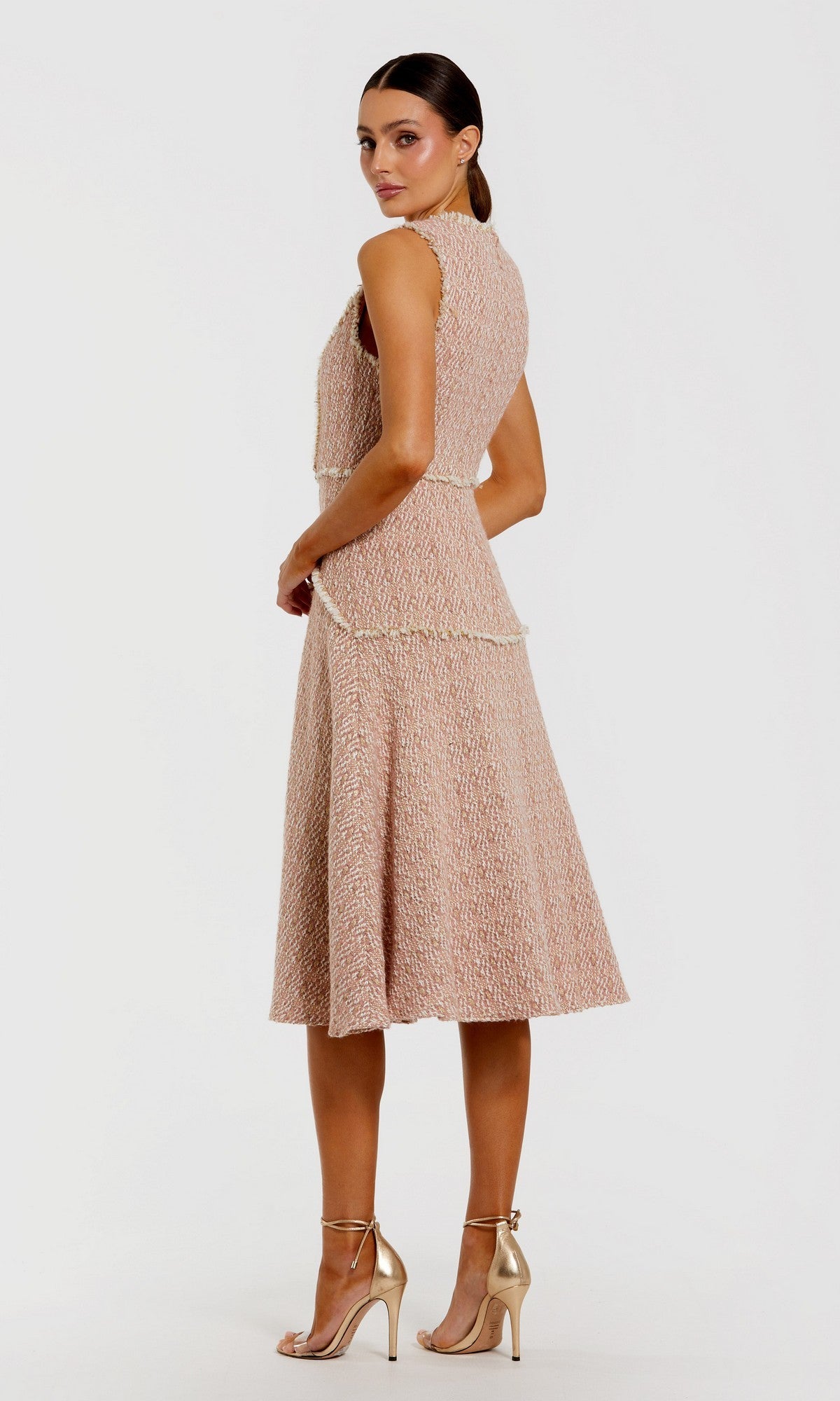 A woman models the Button-Up Boucle Midi Dress: Mac Duggal 56172 in textured blush pink with faux pearl buttons, paired with gold high heels, standing slightly angled against a plain white background.