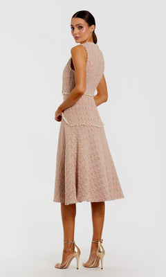 A woman models the Button-Up Boucle Midi Dress: Mac Duggal 56172 in textured blush pink with faux pearl buttons, paired with gold high heels, standing slightly angled against a plain white background.