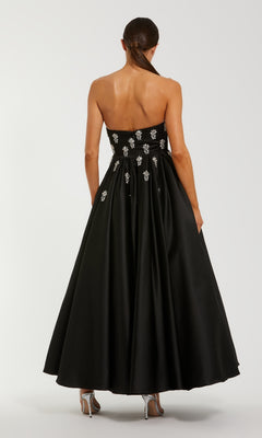 Black strapless dress with an a-line skirt on a white background