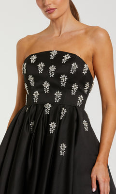 Black strapless dress with crystal floral embellishments on a plain background