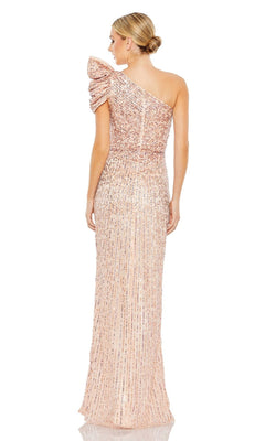 A woman is shown from the back wearing the Mac Duggal Long Formal Dress 5622, a blush pink sequined, floor-length gown with a one-shoulder design and ruched sleeve.