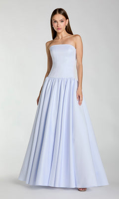 A woman wearing the Mac Duggal 56270 long formal dress—a floor-length, powder blue gown with a fitted bodice and a flared A-line skirt—stands against a plain background.