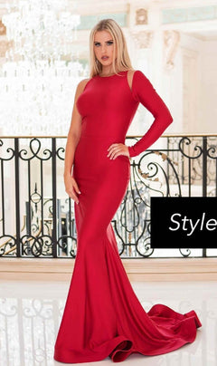 Woman wearing the Jessica Angel 563: a fitted, floor-length red prom dress with one sleeve and shoulder cutouts, posing indoors by an ornate railing and chandelier.