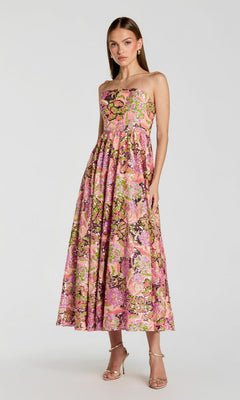 A woman wearing the Mac Duggal 56386 Tea-Length Party Dress in Orchid Multi stands against a plain background.