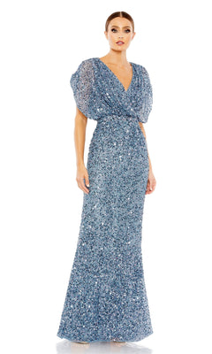 A woman faces forward wearing the Mac Duggal 5640 Short Sleeve Long Sequin Formal Dress, a blue floor-length gown with puff sleeves and a V-neckline.