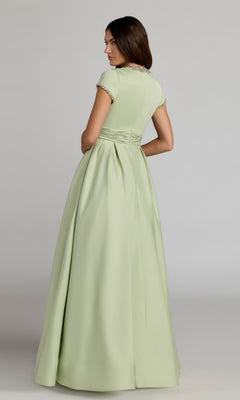 A woman is shown from the back against a plain background, wearing the Long Formal Dress: Mac Duggal 56402—a light green, short-sleeve, floor-length gown with pleated detailing. This elegant sage green dress features luxurious fabric and exquisite design for a timeless look.