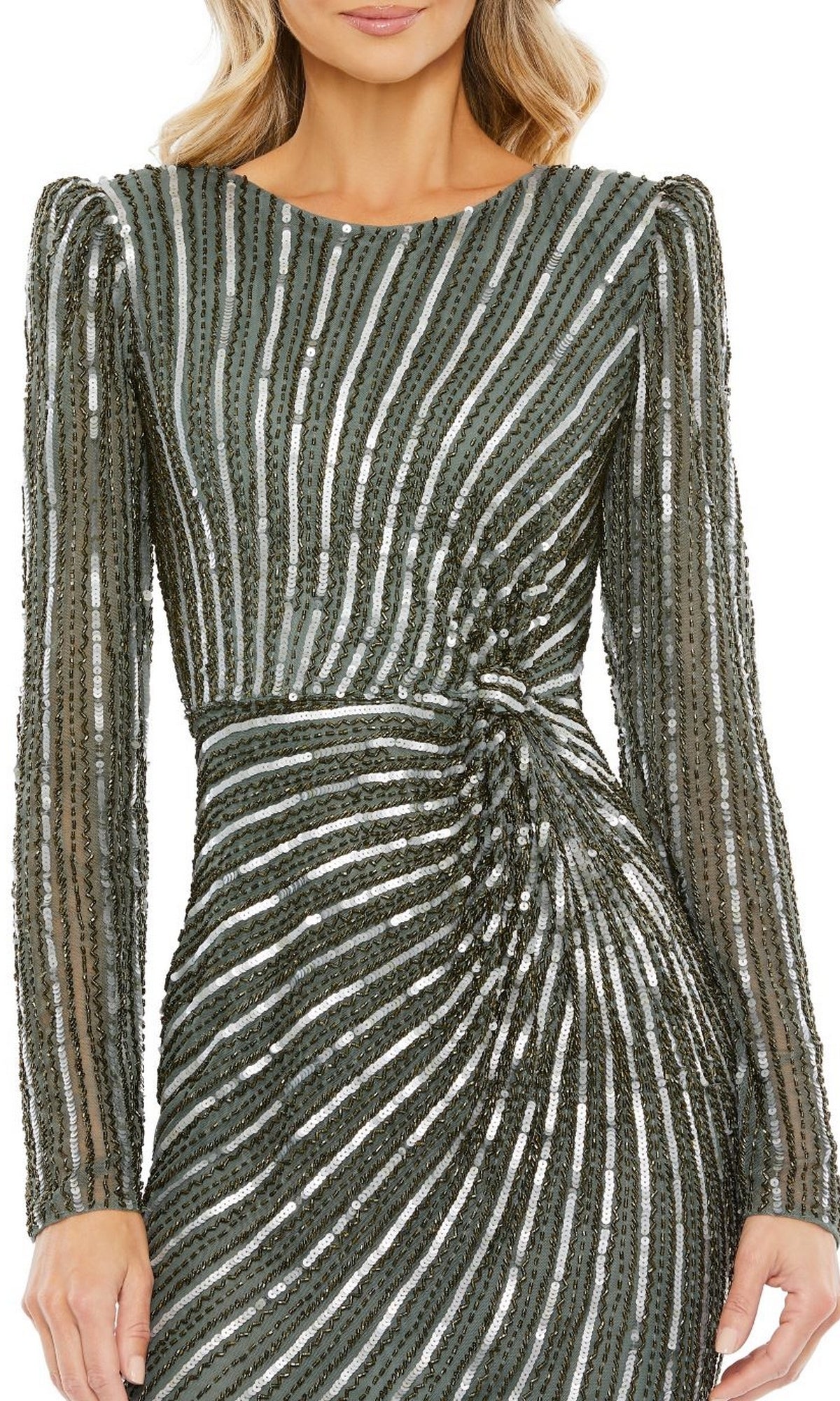 A woman wearing the Mac Duggal 5641 Long-Sleeve Sequin Formal Dress in green, detailed with vertical and diagonal silver sequin stripes and a gathered waist.