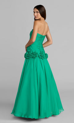 Woman wearing the Mac Duggal 56428 long formal dress—a strapless, floor-length green gown featuring a drop waist and floral embellishments at the hips—standing against a plain gray background.
