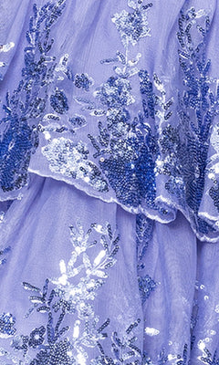 Close-up of the Blondie Nites 5702BN short prom dress featuring lavender sheer fabric with blue and silver floral sequin embroidery, layered ruffles, and elegant details perfect for a fit-and-flare style.