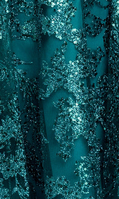 Close-up of teal fabric with detailed sequin and lace embroidery, ideal for a Mini Green Sequin Hoco Dress: Blondie Nites 5705BN, perfect for juniors seeking a standout homecoming look.