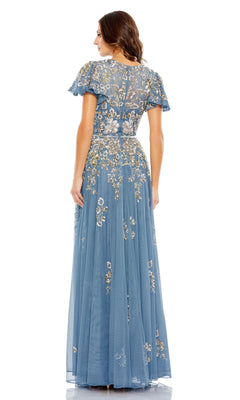 Woman wearing the Mac Duggal 5717 Short Sleeve Beaded Formal Dress, a blue floor-length gown with floral embroidery and sheer overlay, shown from the back against a white background.