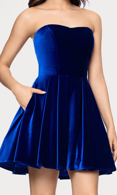 A woman wears the Short Velvet Hoco Dress: Blondie Nites 5718BN—an affordable, strapless royal blue velvet fit-and-flare cocktail dress with a sweetheart neckline and side pockets.