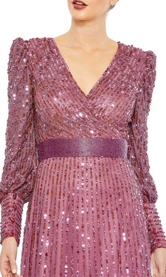 Woman wearing the Mac Duggal 5720 long sleeve sequin formal dress in mauve, featuring a V-neckline and textured waistband—an elegant choice for evening events or as a mother of the bride. Shown from shoulders to mid-thigh.
