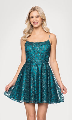A woman smiles in the Mini Teal Glitter Hoco Dress: Blondie Nites 5802BN, featuring sequins and thin straps. This teal party dress is perfect for making a statement at your next event.