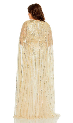A woman faces away from the camera in the Mac Duggal Long Plus-Size Formal Dress 5804, a floor-length gold sequin gown with a sheer cape—an elegant choice for special occasions.