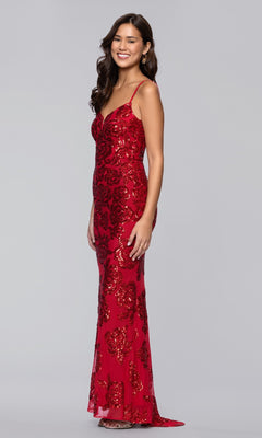 A woman stands and smiles against a plain light background, wearing the Long Prom Dress: Blondie Nites 5905BN, a sleeveless sequined gown with floral patterns.