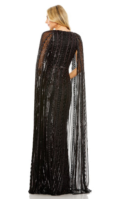 A woman faces away, wearing the Long Formal Dress 5915 by Mac Duggal—a sequin gown with a v-neckline and sheer, floor-length cape-like sleeves.