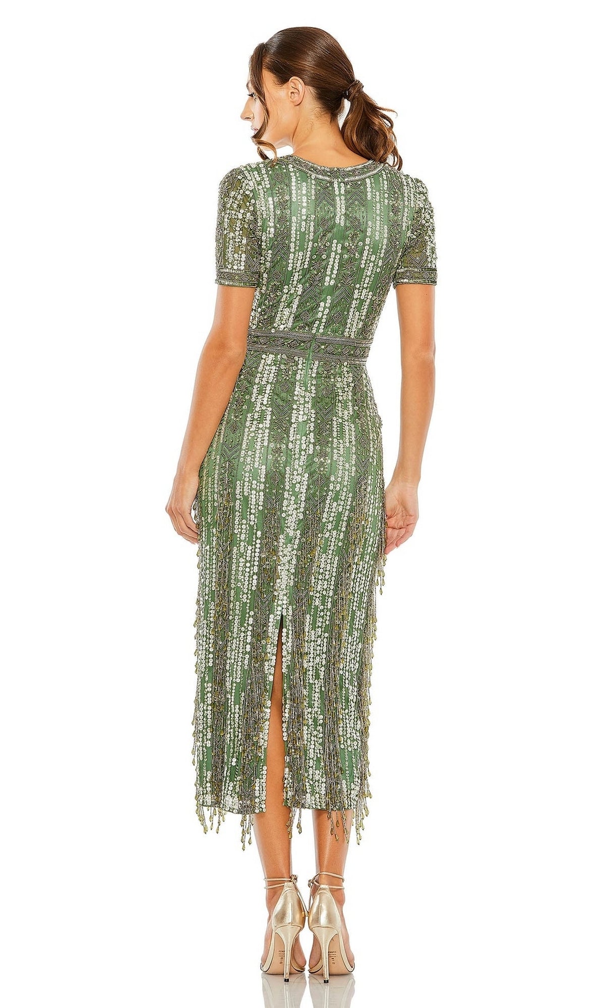 A woman faces away from the camera wearing the Mac Duggal 5980 Midi Fringe Wedding-Guest Dress, a green sequin short-sleeve midi with a back slit—ideal for semi-formal events or as a chic wedding-guest dress—paired with metallic heels.