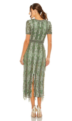 A woman faces away from the camera wearing the Mac Duggal 5980 Midi Fringe Wedding-Guest Dress, a green sequin short-sleeve midi with a back slit—ideal for semi-formal events or as a chic wedding-guest dress—paired with metallic heels.