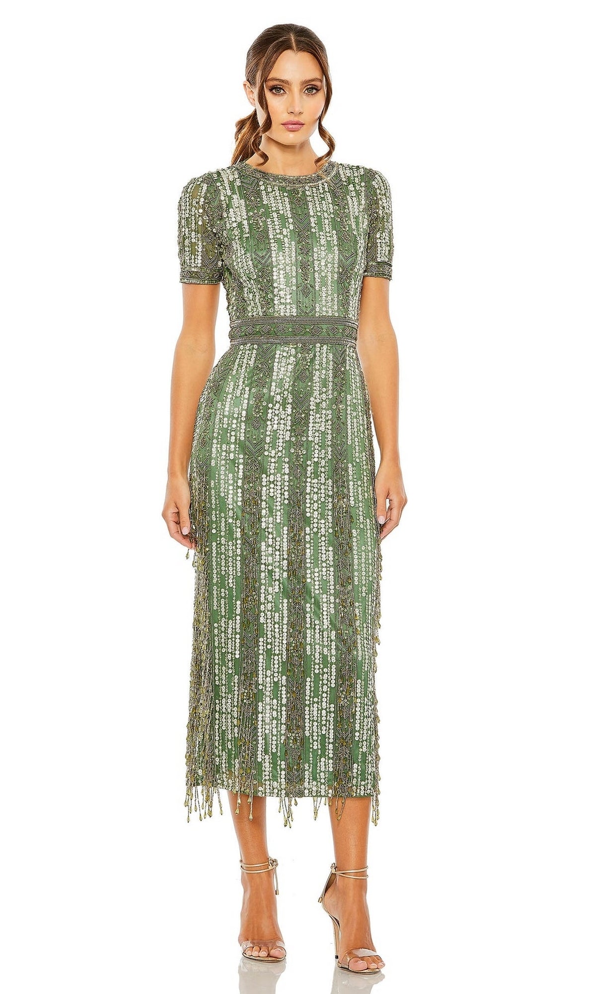 A woman faces forward in the Mac Duggal 5980 Midi Fringe Wedding-Guest Dress, featuring green sequins and short sleeves, styled with silver high-heeled sandals for a chic semi-formal look.