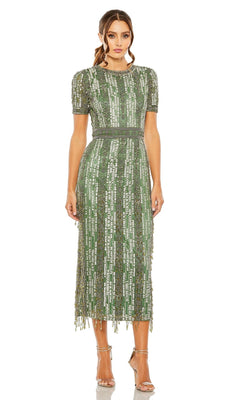 A woman faces forward in the Mac Duggal 5980 Midi Fringe Wedding-Guest Dress, featuring green sequins and short sleeves, styled with silver high-heeled sandals for a chic semi-formal look.