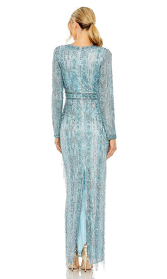 A woman with blonde hair in a low ponytail is seen from behind wearing the Long Formal Dress 5981 by Mac Duggal, a light blue beaded fringe gown with long sleeves, back slit, and striking fringe accents.