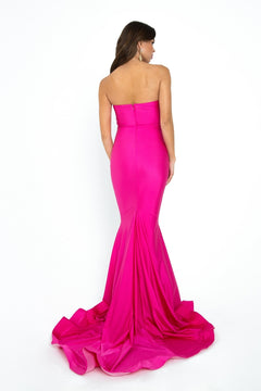 A woman in the Strapless Sleek Long Prom Dress: Atria 6028H poses with her back to the camera, its vibrant pink mermaid skirt flowing gracefully on the floor against a white background.