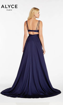 A woman faces away from the camera in the Alyce 60453, a navy blue satin evening gown with double spaghetti straps, an open back, and a long flowing train for an elegant look.