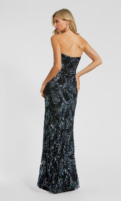 A woman models the Mac Duggal 6046 Long Formal Dress: a strapless, floor-length black gown adorned with shimmering sequins and elegant embellishments, fitted to perfection as she stands with her back turned, glancing over her shoulder.