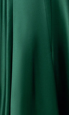 Close-up of green fabric with smooth texture and gentle folds, inspired by the Blondie Nites 6088BN long prom dress featuring an a-line satin skirt, sequin embellished bodice, and sweetheart neckline.