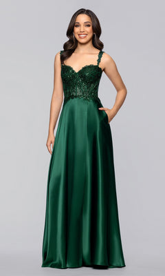 A woman stands against a light gray background wearing the Blondie Nites 6088BN long prom dress, featuring an a-line satin silhouette with a floor-length dark green skirt and a sleeveless, sequin-embellished bodice.
