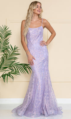 A woman with long wavy blonde hair poses indoors near a potted plant, wearing the Iridescent Long Embellished Prom Dress 6116— a fitted, floor-length lavender gown with thin straps.