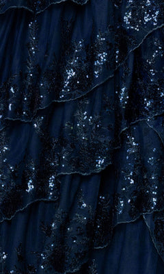 Close-up of the Blondie Nites 6126BN long prom dress, featuring dark blue layered ruffles and sparkling sequins for a shimmering corset-style bodice and tiered A-line skirt.
