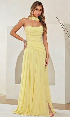 A woman stands indoors against a minimalist background, wearing the Amelia Couture 6133 Strapless Chiffon Prom Gown with a ruched corset bodice and matching neck scarf.