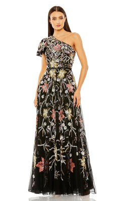 A woman stands wearing the Long Formal Dress 6134 by Mac Duggal, a black, floor-length, one-shoulder formal gown adorned with colorful floral embroidery.